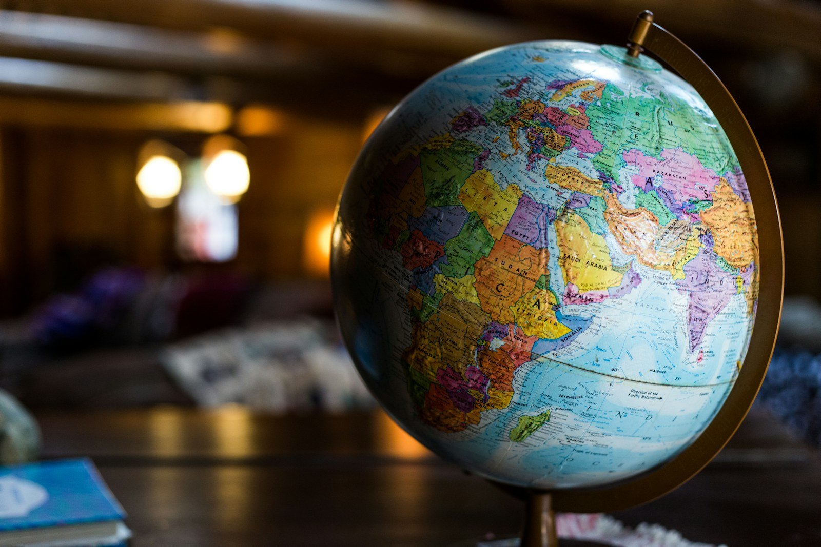 A desk globe turned to show India, the Arabian Gulf and Europe.